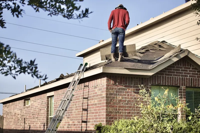 Professional roofer working on a residential roof in Weller Estates